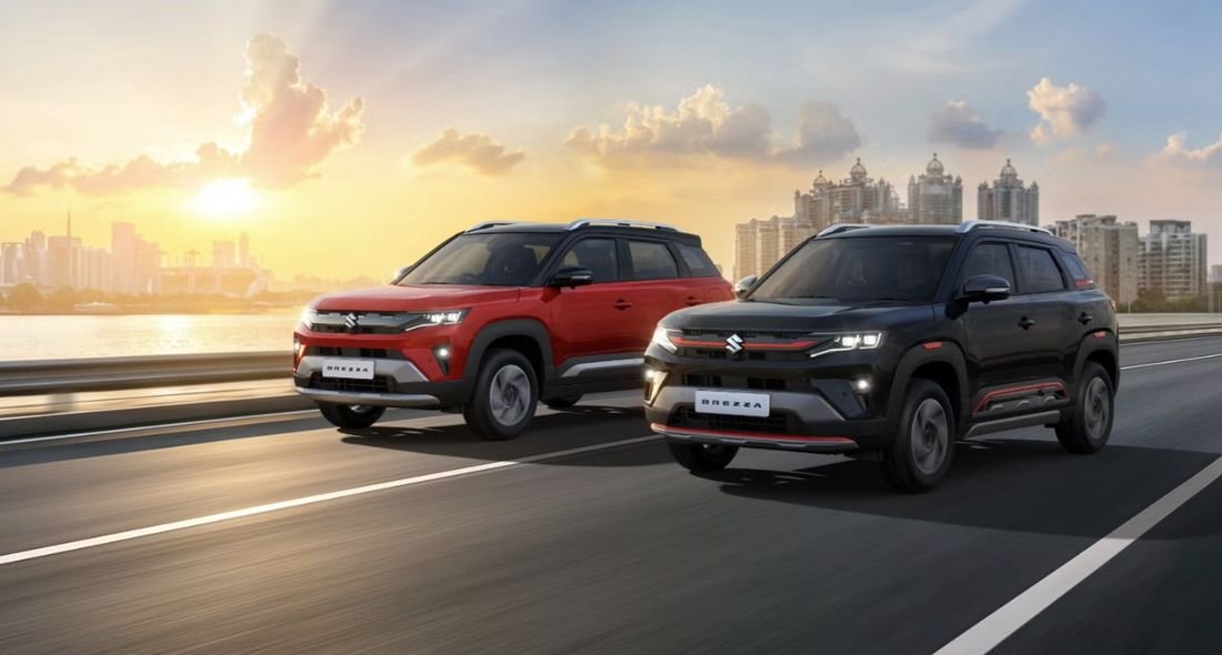 Two 2026 Maruti Brezza variants, red and black, driving side by side