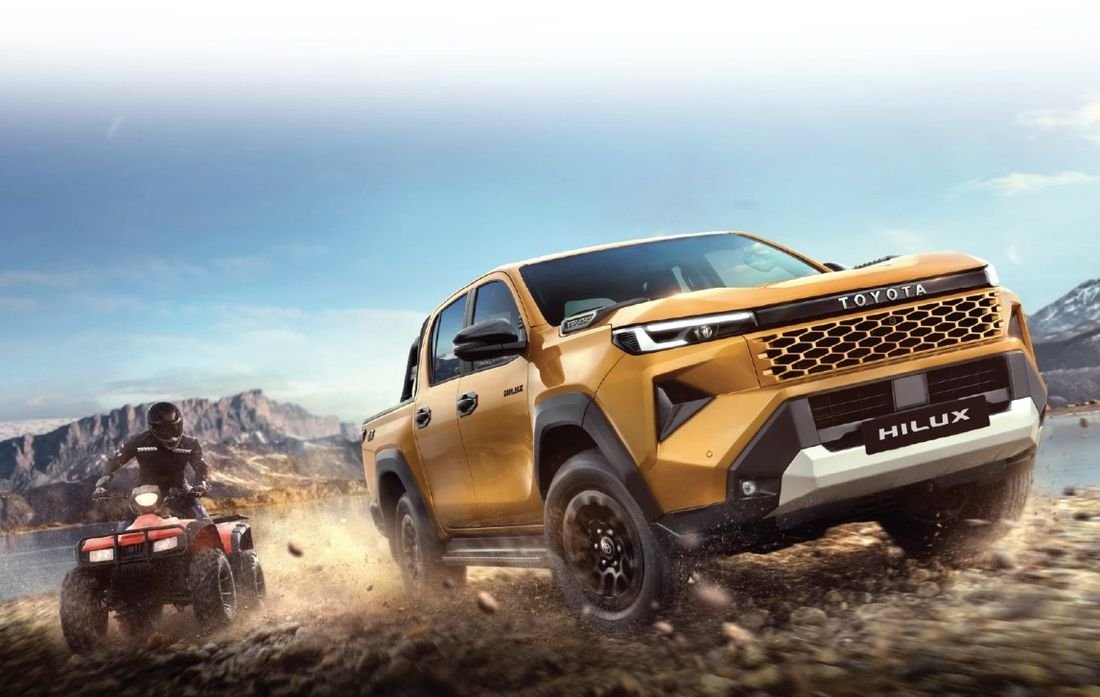New Toyota Hilux driving off-road through rocky terrain