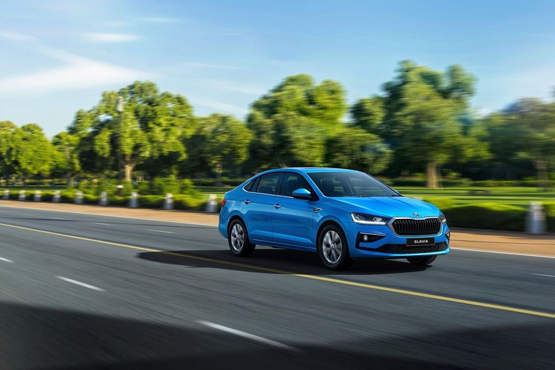 2026 Skoda Slavia facelift in Crystal Blue driving on an open road, front three-quarter view