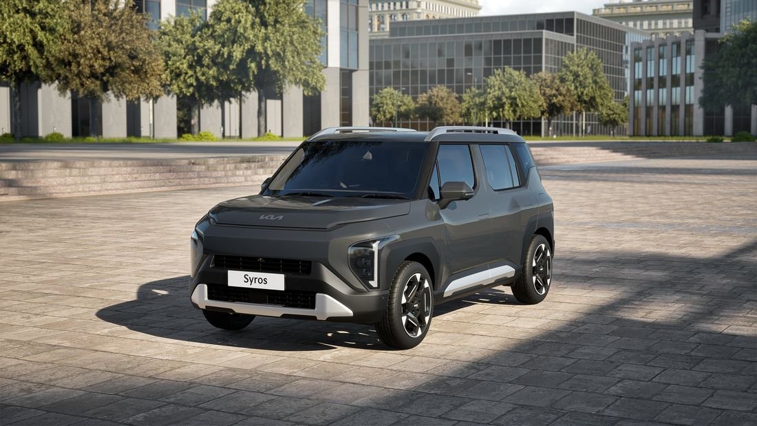 Kia Syros EV parked in a city plaza